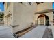 Inviting front porch with a decorative iron gate and stone accents, adding charm and security at 6828 Sumatra St, Las Vegas, NV 89166