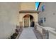 Inviting front porch with a decorative iron gate and stone accents, adding charm and security at 6828 Sumatra St, Las Vegas, NV 89166