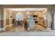 Eat-in kitchen features stainless appliances, center island with bar seating, and tile flooring at 6828 Sumatra St, Las Vegas, NV 89166