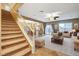 Inviting living room with staircase leading to upper level and views of the kitchen at 6828 Sumatra St, Las Vegas, NV 89166