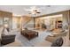 Open-concept living room and kitchen offers a spacious design with staircase and neutral décor at 6828 Sumatra St, Las Vegas, NV 89166
