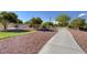 Serene park with a paved path, picnic tables, and lush landscaping for outdoor enjoyment at 6828 Sumatra St, Las Vegas, NV 89166
