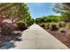 Paved walking path amidst lush greenery, ideal for serene neighborhood strolls at 6828 Sumatra St, Las Vegas, NV 89166