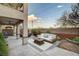 Outdoor patio with stylish seating, fan, and lush landscaping, creating an inviting space at 6828 Sumatra St, Las Vegas, NV 89166
