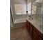 Bright bathroom featuring double vanity sinks, tile flooring, and natural light at 684 Calamus Palm Pl, Henderson, NV 89011