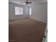 Bedroom featuring neutral carpet, a ceiling fan, and bright windows at 684 Calamus Palm Pl, Henderson, NV 89011