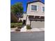 Two story home featuring an attached 2 car garage and desert landscaping at 684 Calamus Palm Pl, Henderson, NV 89011