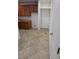 Kitchen featuring tile flooring, wooden cabinets, and access to an exterior door at 684 Calamus Palm Pl, Henderson, NV 89011
