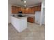 Well-lit kitchen featuring wooden cabinets, stainless steel appliances, and tile flooring at 684 Calamus Palm Pl, Henderson, NV 89011