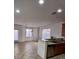 Well-lit kitchen featuring an eat-in breakfast bar, stainless steel appliances, and tile flooring at 684 Calamus Palm Pl, Henderson, NV 89011