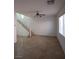 Open living room with tile floors and a staircase at 684 Calamus Palm Pl, Henderson, NV 89011