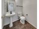 Powder room featuring a pedestal sink, toilet, and tile flooring at 6913 Mill Creek Way, Las Vegas, NV 89149