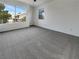 Spacious bedroom with carpet flooring, natural light from two windows offering neighborhood views at 6913 Mill Creek Way, Las Vegas, NV 89149