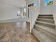 Inviting entryway featuring tile flooring, carpeted stairs, and abundant natural light at 6913 Mill Creek Way, Las Vegas, NV 89149