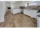 Bright kitchen with stainless steel appliances, tile backsplash, tile floors, and island at 6913 Mill Creek Way, Las Vegas, NV 89149