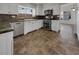 Well-lit kitchen with stainless steel appliances, tile backsplash, and tile floors at 6913 Mill Creek Way, Las Vegas, NV 89149