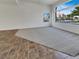 Bright living room featuring neutral carpeting and tile flooring, with large windows for natural light at 6913 Mill Creek Way, Las Vegas, NV 89149