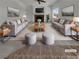 Staged living room featuring neutral colors, fireplace, plush seating, and plenty of natural light at 6913 Mill Creek Way, Las Vegas, NV 89149