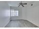 A bedroom with wood-look flooring and a window lets in natural light at 7151 S Durango Dr # 211, Las Vegas, NV 89113