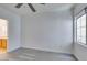 This bedroom features wood-look flooring, a ceiling fan, and a bathroom at 7151 S Durango Dr # 211, Las Vegas, NV 89113