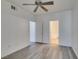 A bedroom with wood-look flooring and two doors leading to bathrooms at 7151 S Durango Dr # 211, Las Vegas, NV 89113