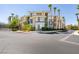 Beautiful condo building with lush landscaping and palm trees providing a relaxing atmosphere at 7151 S Durango Dr # 211, Las Vegas, NV 89113