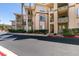 Exterior view of a multi-story condo building with balconies and well-maintained landscaping at 7151 S Durango Dr # 211, Las Vegas, NV 89113