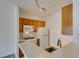 Compact kitchen featuring oak cabinetry and white appliances at 7151 S Durango Dr # 211, Las Vegas, NV 89113