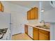 Functional kitchen featuring wooden cabinets and essential appliances at 7151 S Durango Dr # 211, Las Vegas, NV 89113