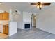 Bright living room features a cozy fireplace, and modern gray wood flooring at 7151 S Durango Dr # 211, Las Vegas, NV 89113