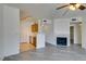 Open floor plan featuring gray wood floors, fireplace, and a view to the kitchen at 7151 S Durango Dr # 211, Las Vegas, NV 89113