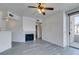 Open floor plan featuring gray wood floors, fireplace, and a ceiling fan at 7151 S Durango Dr # 211, Las Vegas, NV 89113