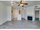 Open floor plan featuring gray wood floors, fireplace, and a view to the kitchen at 7151 S Durango Dr # 211, Las Vegas, NV 89113