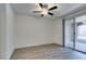 Spacious bedroom with wood-look flooring and a sliding glass door to the patio at 7163 S Durango Dr # 302, Las Vegas, NV 89113