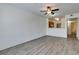 Open-concept living room with modern floors, ceiling fan, and seamless flow to the kitchen and bathroom at 7163 S Durango Dr # 302, Las Vegas, NV 89113