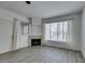 Bright living room featuring modern flooring, a cozy fireplace, and a large window for ample natural light at 7163 S Durango Dr # 302, Las Vegas, NV 89113
