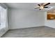 Open-concept living room with modern floors, ceiling fan, and seamless flow to the kitchen area at 7163 S Durango Dr # 302, Las Vegas, NV 89113
