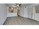 Open-concept living room with modern floors and seamless flow to the kitchen and entry door at 7163 S Durango Dr # 302, Las Vegas, NV 89113