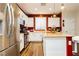 Modern kitchen features stainless steel appliances, white cabinets, a kitchen island, and pendant lighting at 7214 Regent Pond St, Las Vegas, NV 89166