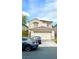 Two-story home featuring a terracotta roof, a two-car garage, and manicured landscaping at 7640 Highland Pony St, Las Vegas, NV 89149