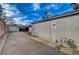 Backyard exterior featuring a long driveway, brick patio and block wall, creating a secure and private outdoor space at 806 Fireweed Dr, Henderson, NV 89002