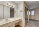 Bathroom with a sink and a doorway to the adjacent bedroom at 806 Fireweed Dr, Henderson, NV 89002