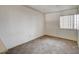 Cozy bedroom with neutral walls, a window, and tile flooring at 806 Fireweed Dr, Henderson, NV 89002