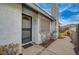 Inviting front entry with textured walls, decorative door, and access to a side yard at 806 Fireweed Dr, Henderson, NV 89002