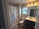 Bathroom with a shower-tub combo, neutral walls, and a stylish nautical-themed shower curtain at 8105 Switchback Run St, Las Vegas, NV 89166