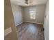 Cozy bedroom featuring neutral walls, wood-look flooring, and a bright window at 8105 Switchback Run St, Las Vegas, NV 89166