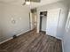 Neutral bedroom featuring wood-look flooring, a ceiling fan, and a closet with sliding doors at 8105 Switchback Run St, Las Vegas, NV 89166