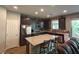 Modern kitchen with granite countertops, stainless steel appliances, and a breakfast bar with stool seating at 8105 Switchback Run St, Las Vegas, NV 89166