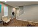 Cozy living room features wood floors, a comfortable armchair, and lots of natural light from the window at 8105 Switchback Run St, Las Vegas, NV 89166