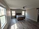 Spacious main bedroom featuring wood floors, natural lighting, and ample closet space at 8105 Switchback Run St, Las Vegas, NV 89166